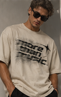 Model wearing a cream T-shirt with a black distorted More Than Music chest graphic
